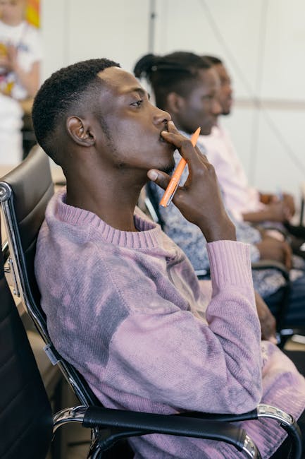 Business professional in a thoughtful pose during a meeting.